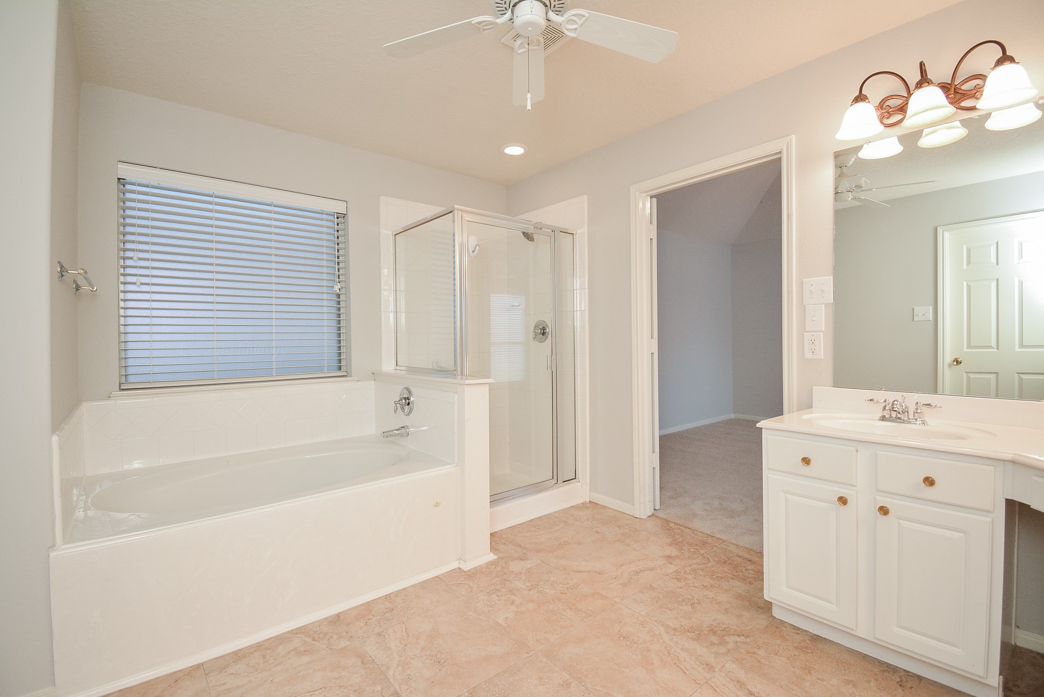 18714 Flagstone Creek Road Houston, TX 77084 - Photo 41 of 50 a bathroom with a tub sink and a mirror
