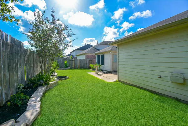 a view of a house with backyard sitting area and garden