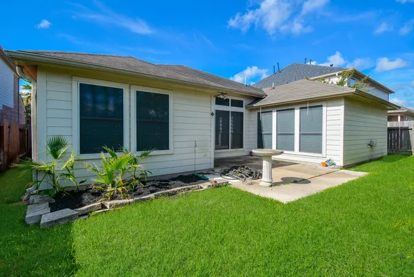 a view of backyard of house with green space