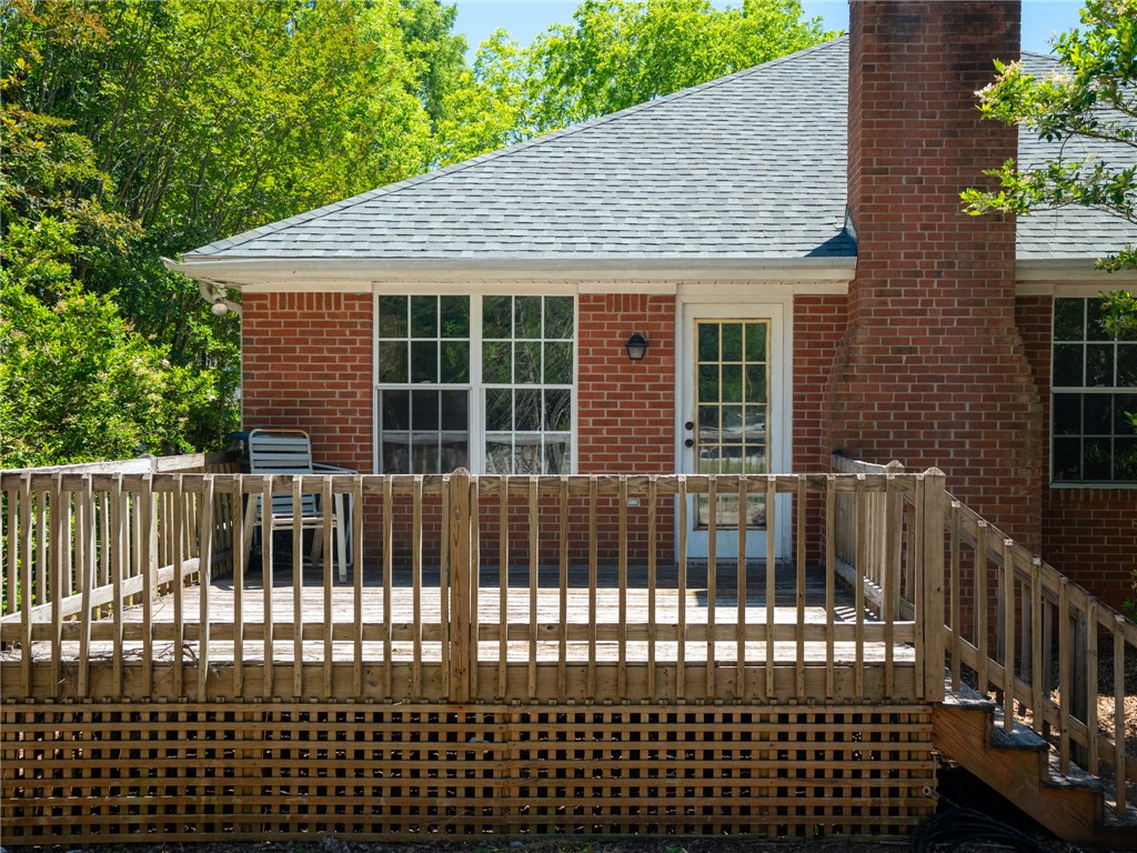 101 Woodbridge Circle Anderson, SC 29621 - Photo 16 of 21 This charming residence features a classic brick exterior, inviting deck, and a lush, verdant backdrop.