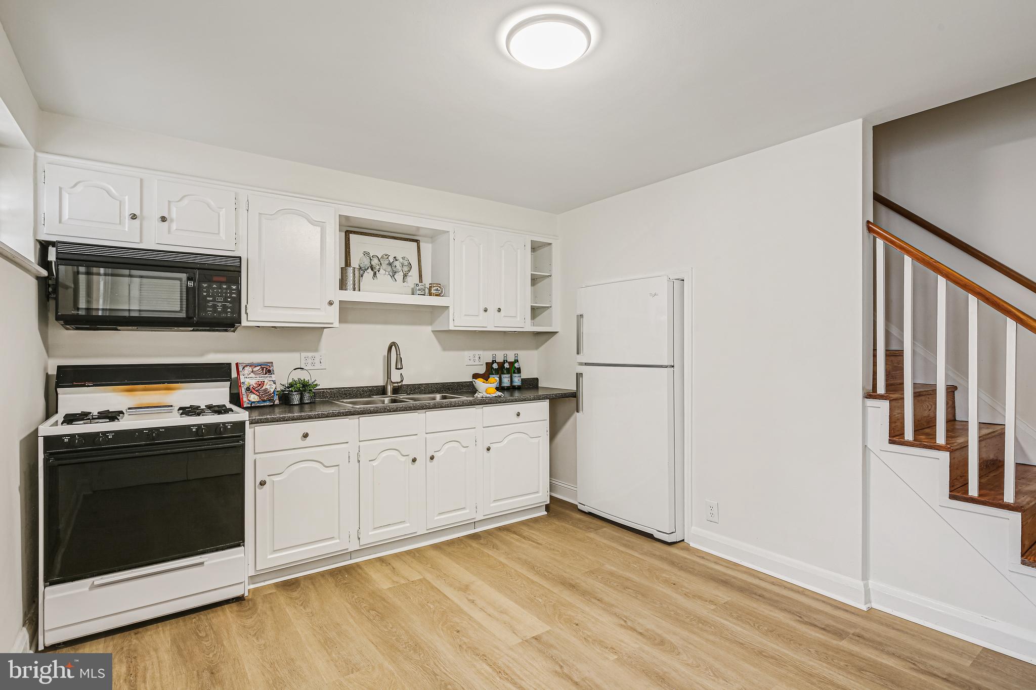 733 Bethnal Road Baltimore, MD 21229 - Photo 30 of 30 a kitchen with stainless steel appliances granite countertop a stove a sink and a refrigerator