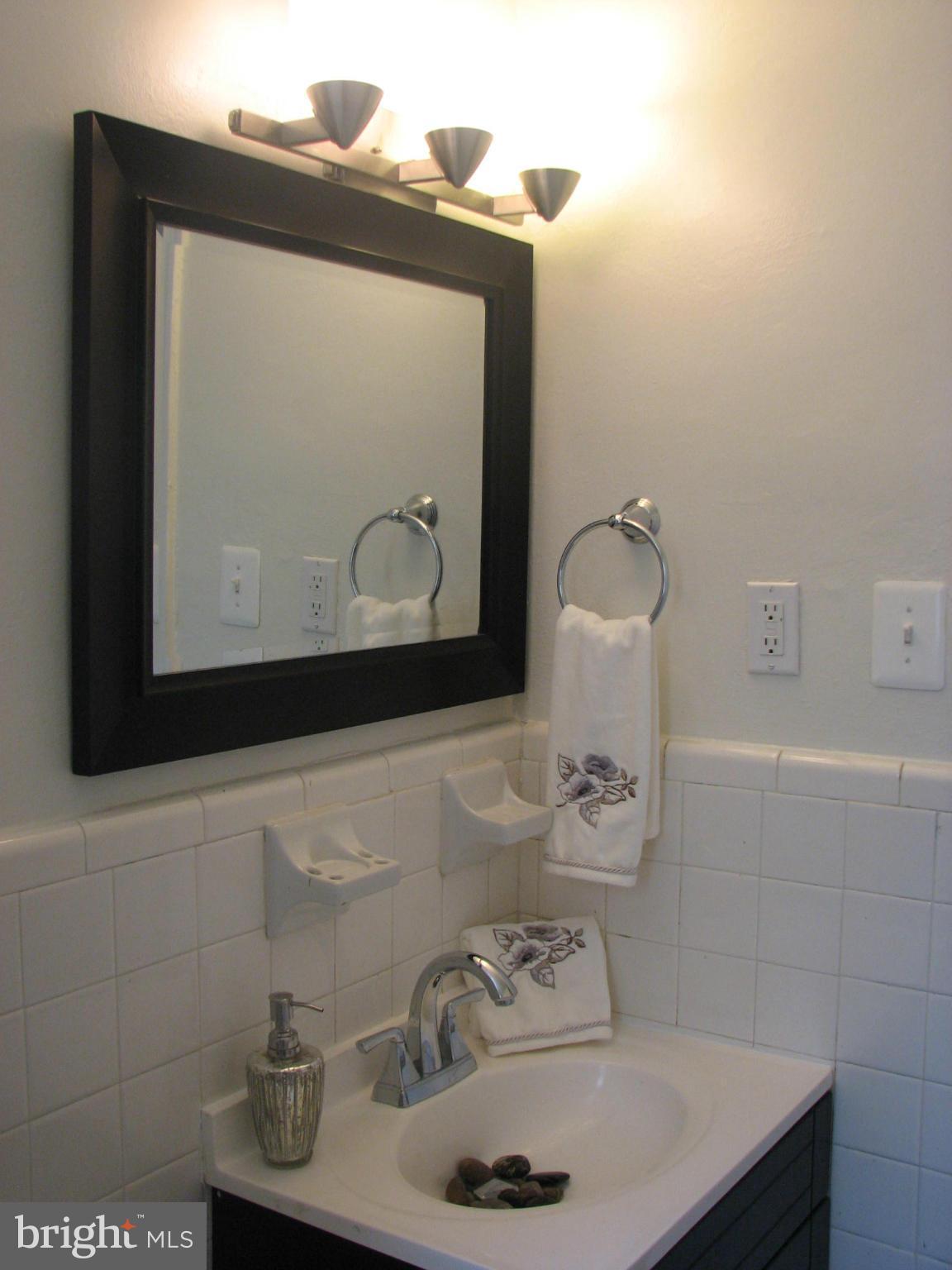 1367 K Street Southeast, Unit 101 Washington, DC 20003 - Photo 11 of 14 a bathroom with a sink and a mirror
