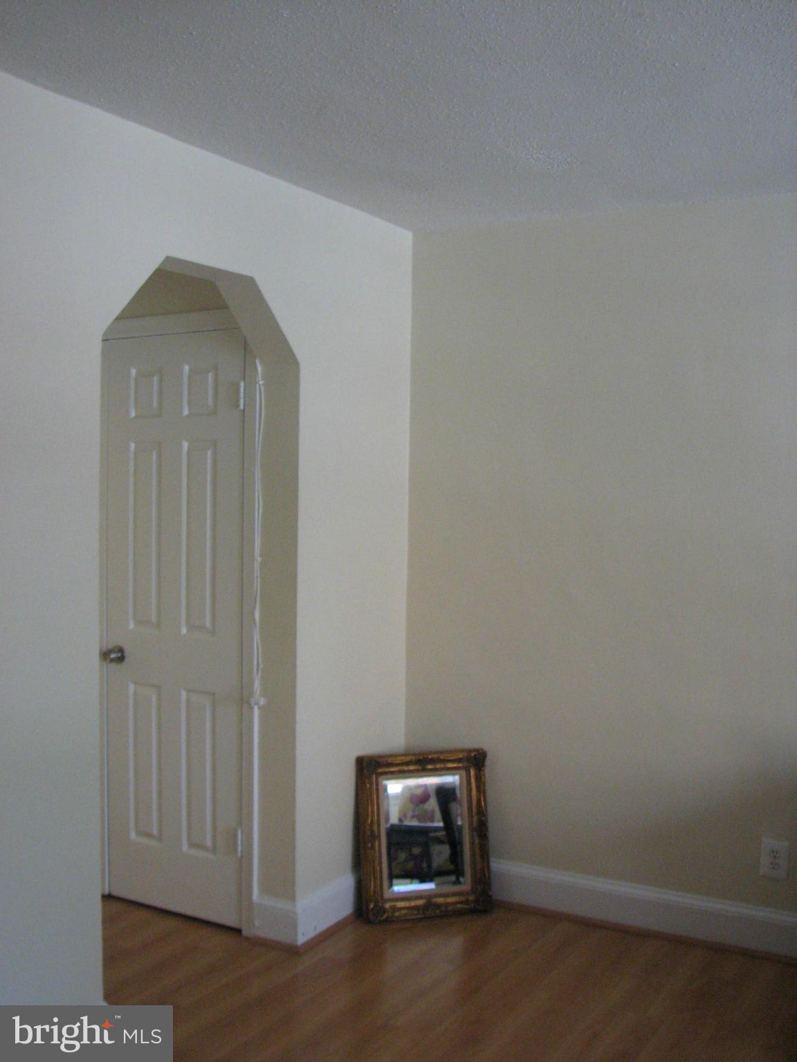 1367 K Street Southeast, Unit 101 Washington, DC 20003 - Photo 6 of 14 an empty room with wooden floor and windows