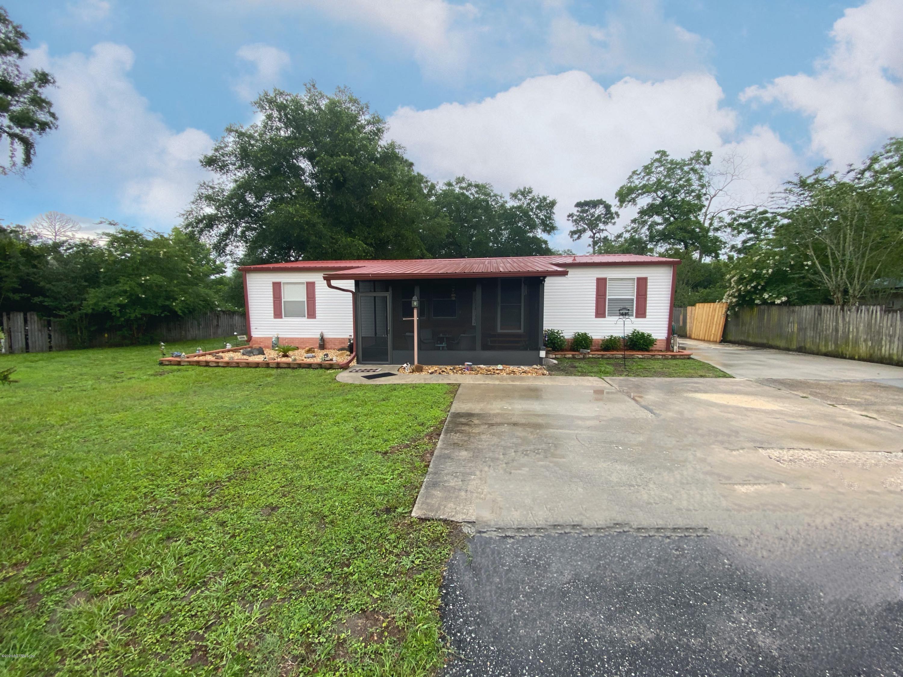 86116 Pages Dairy Road Yulee, FL 32097 - Photo 1 of 46 a front view of a house with garden