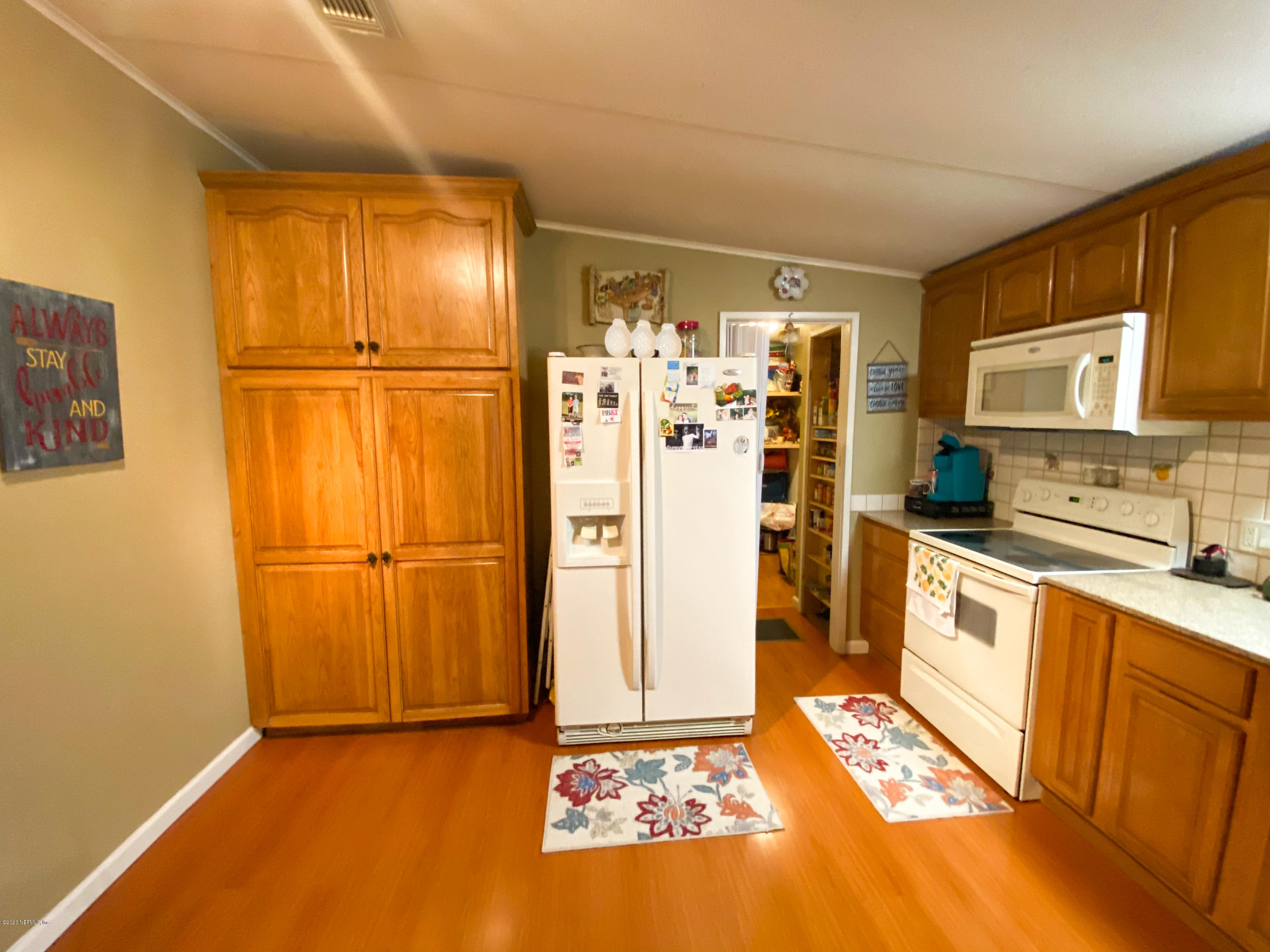 86116 Pages Dairy Road Yulee, FL 32097 - Photo 15 of 46 a kitchen with stainless steel appliances granite countertop a refrigerator and a stove