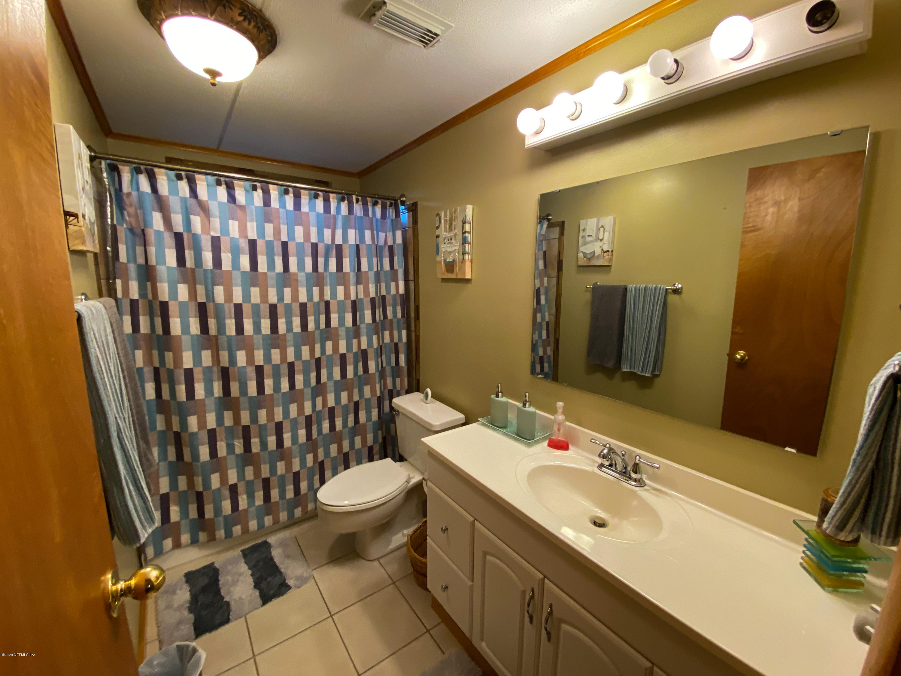 86116 Pages Dairy Road Yulee, FL 32097 - Photo 18 of 46 a bathroom with a sink mirror and toilet