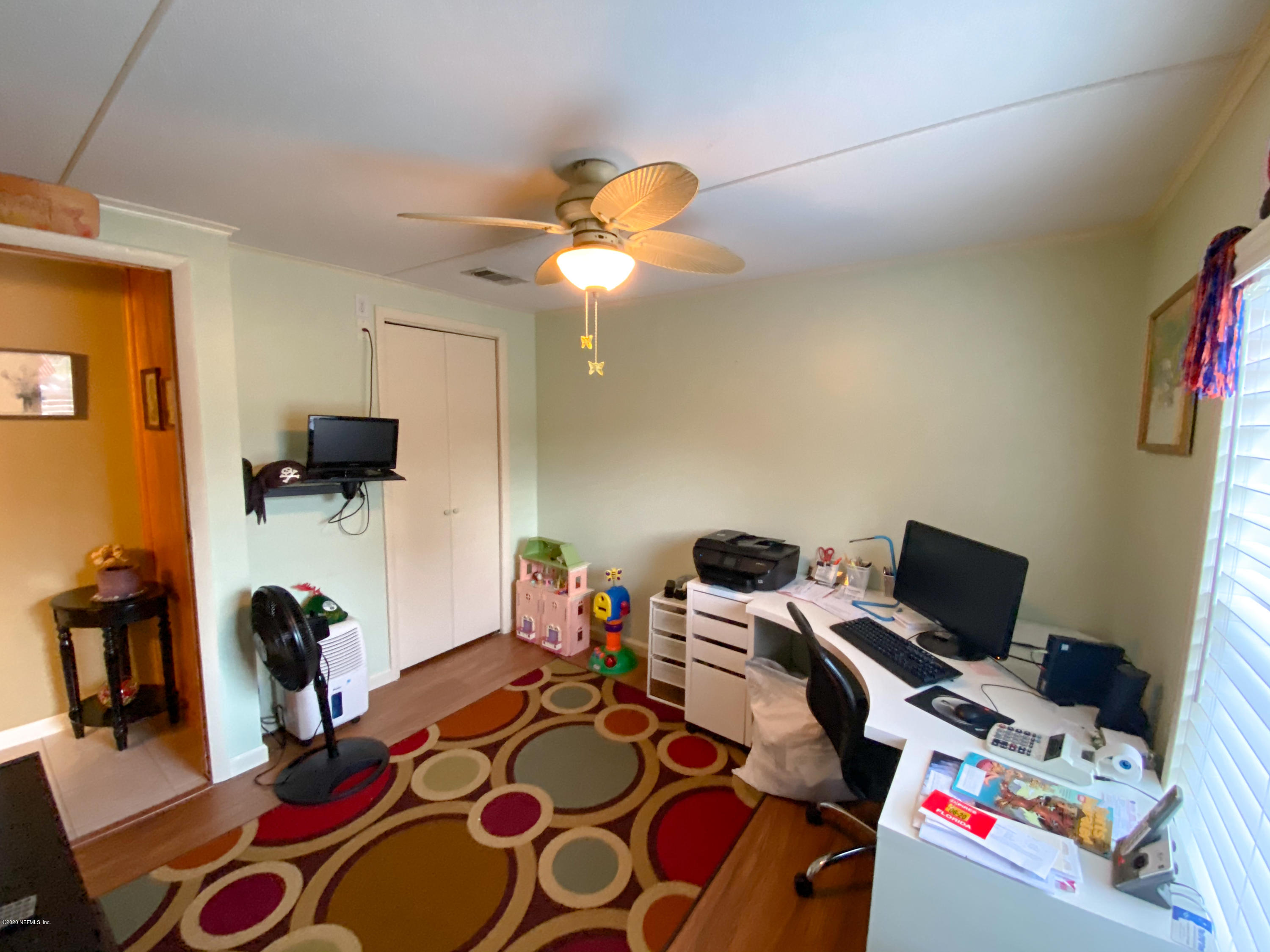 86116 Pages Dairy Road Yulee, FL 32097 - Photo 22 of 46 a bedroom with furniture and a flat screen tv