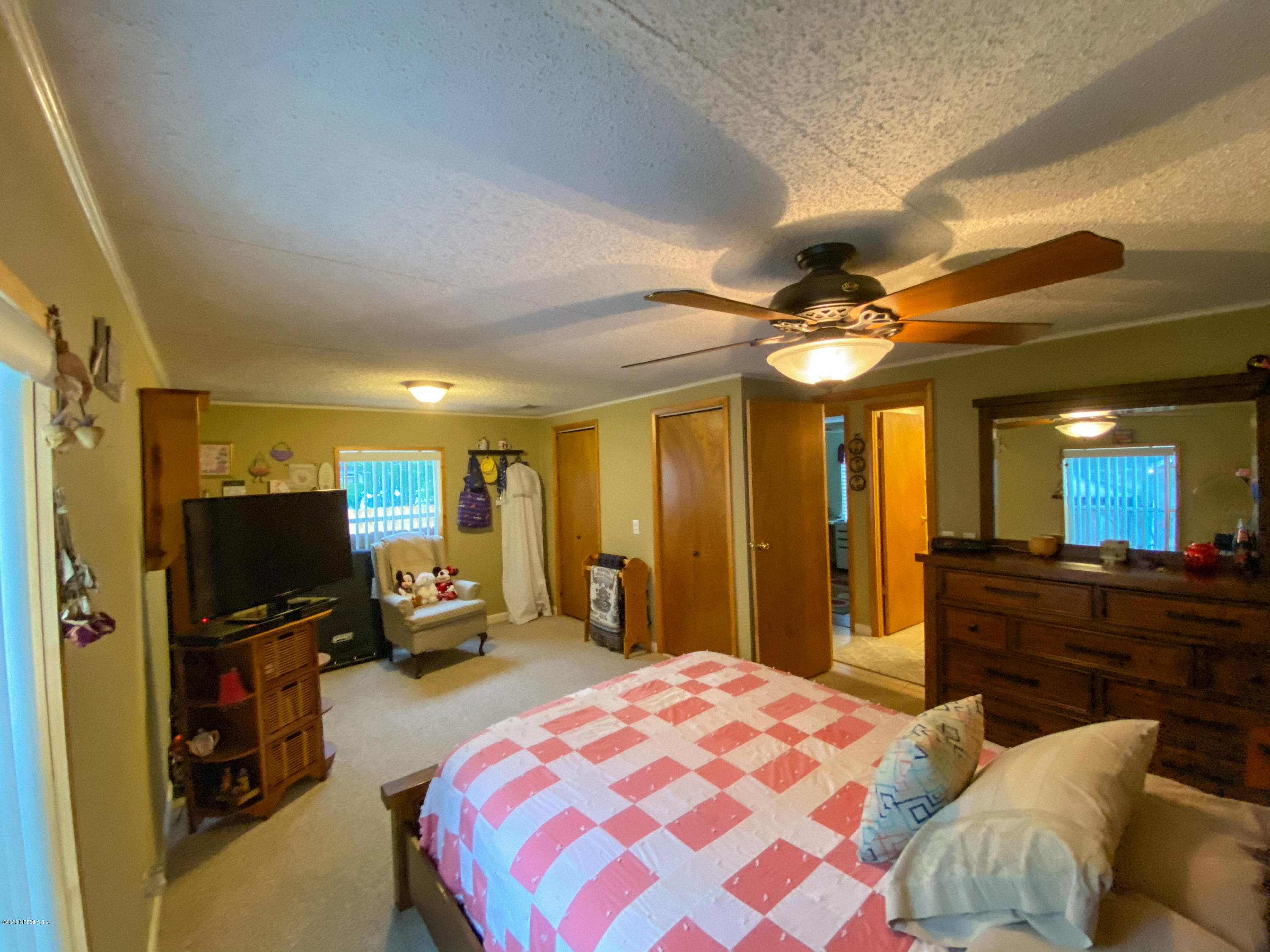 86116 Pages Dairy Road Yulee, FL 32097 - Photo 23 of 46 a bedroom with a bed and a chandelier