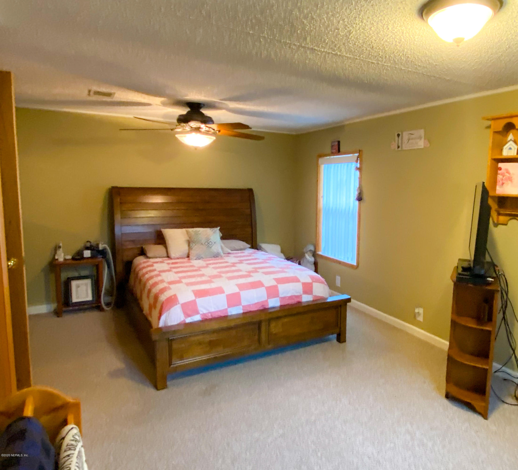 86116 Pages Dairy Road Yulee, FL 32097 - Photo 25 of 46 a bedroom with a bed and gym equipment