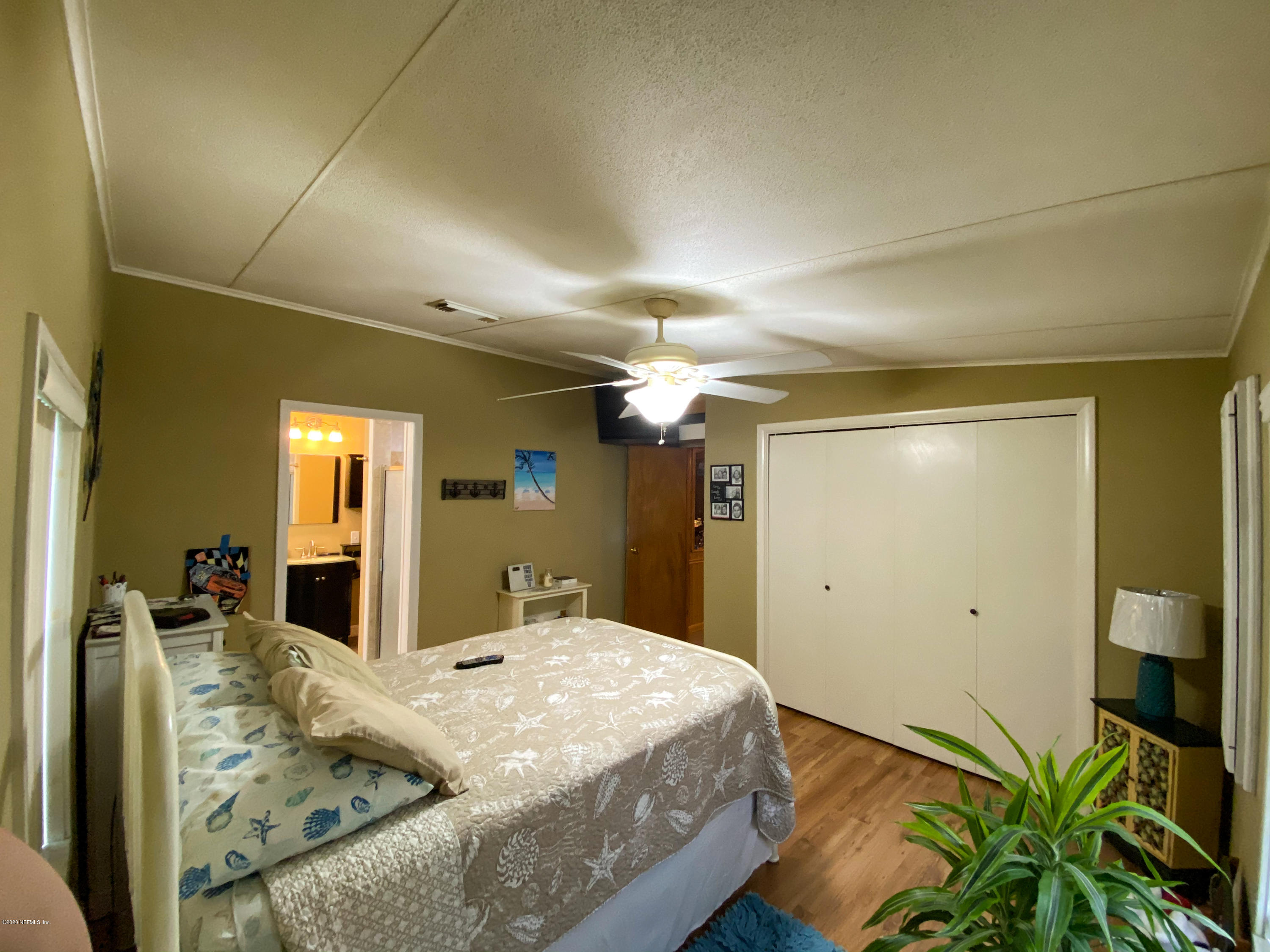 86116 Pages Dairy Road Yulee, FL 32097 - Photo 28 of 46 a bedroom with a bed dresser and a large mirror