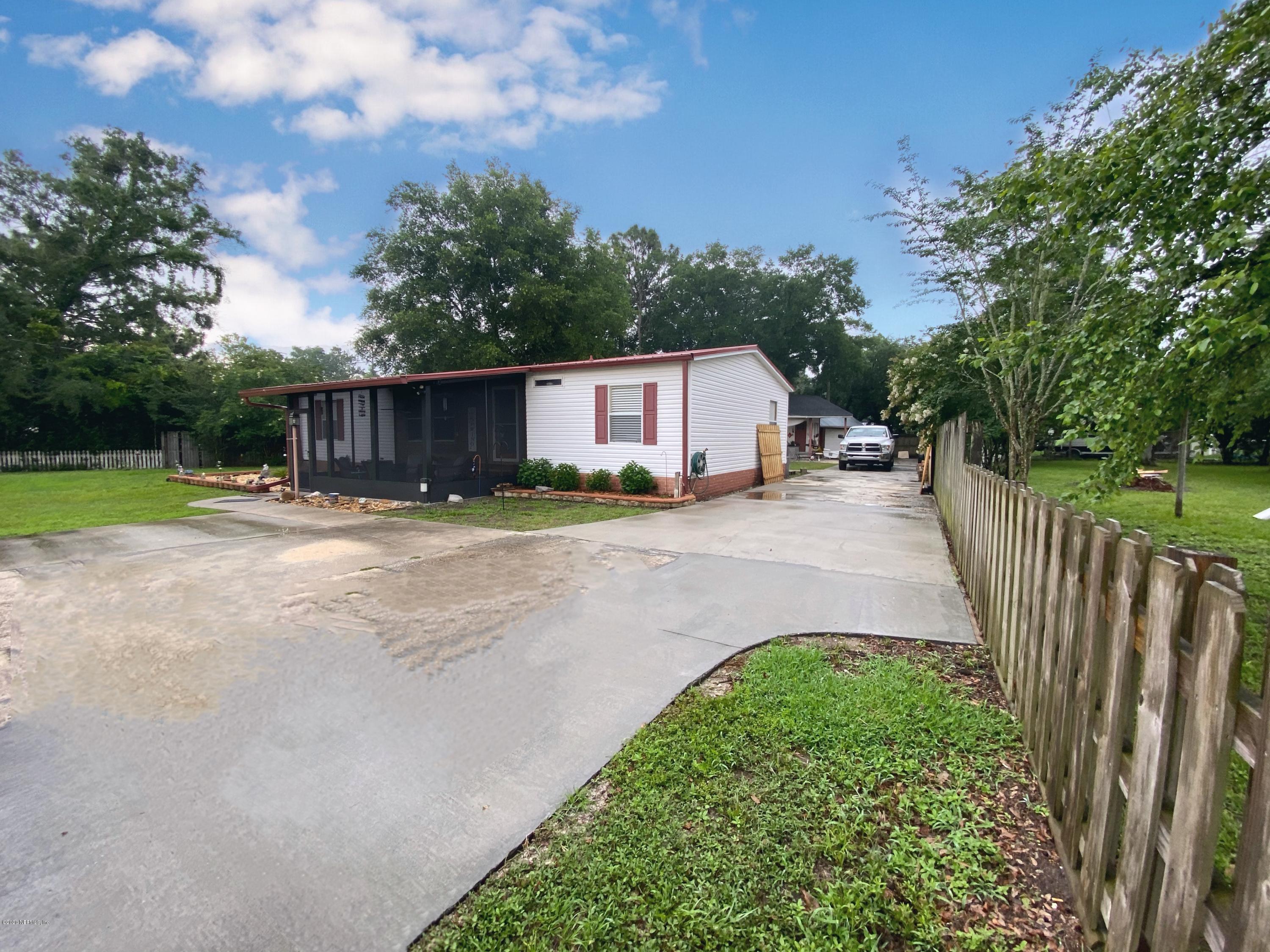 86116 Pages Dairy Road Yulee, FL 32097 - Photo 3 of 46 a backyard of a house with table and chairs