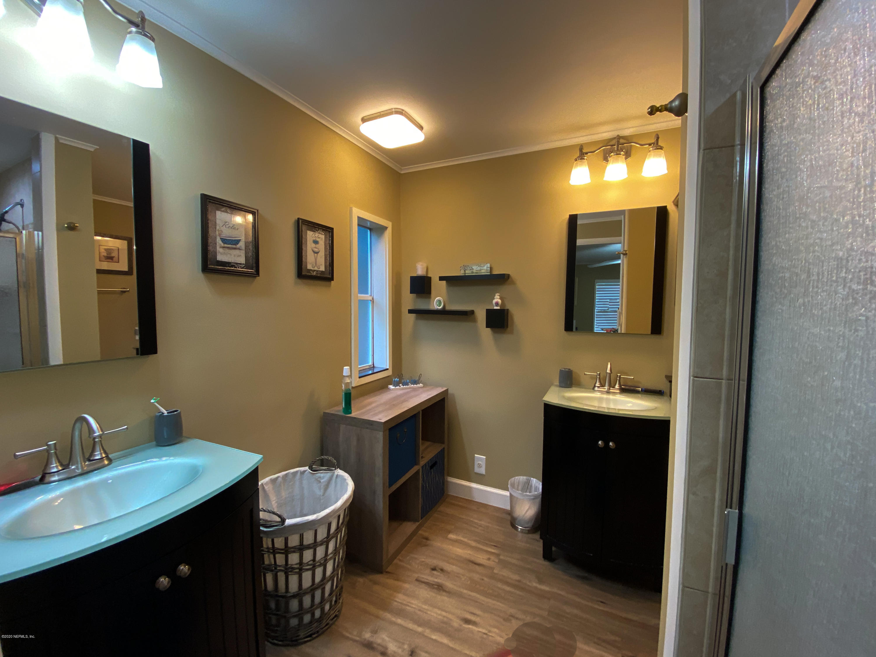 86116 Pages Dairy Road Yulee, FL 32097 - Photo 31 of 46 a bathroom with a double vanity sink toilet mirror and bathtub