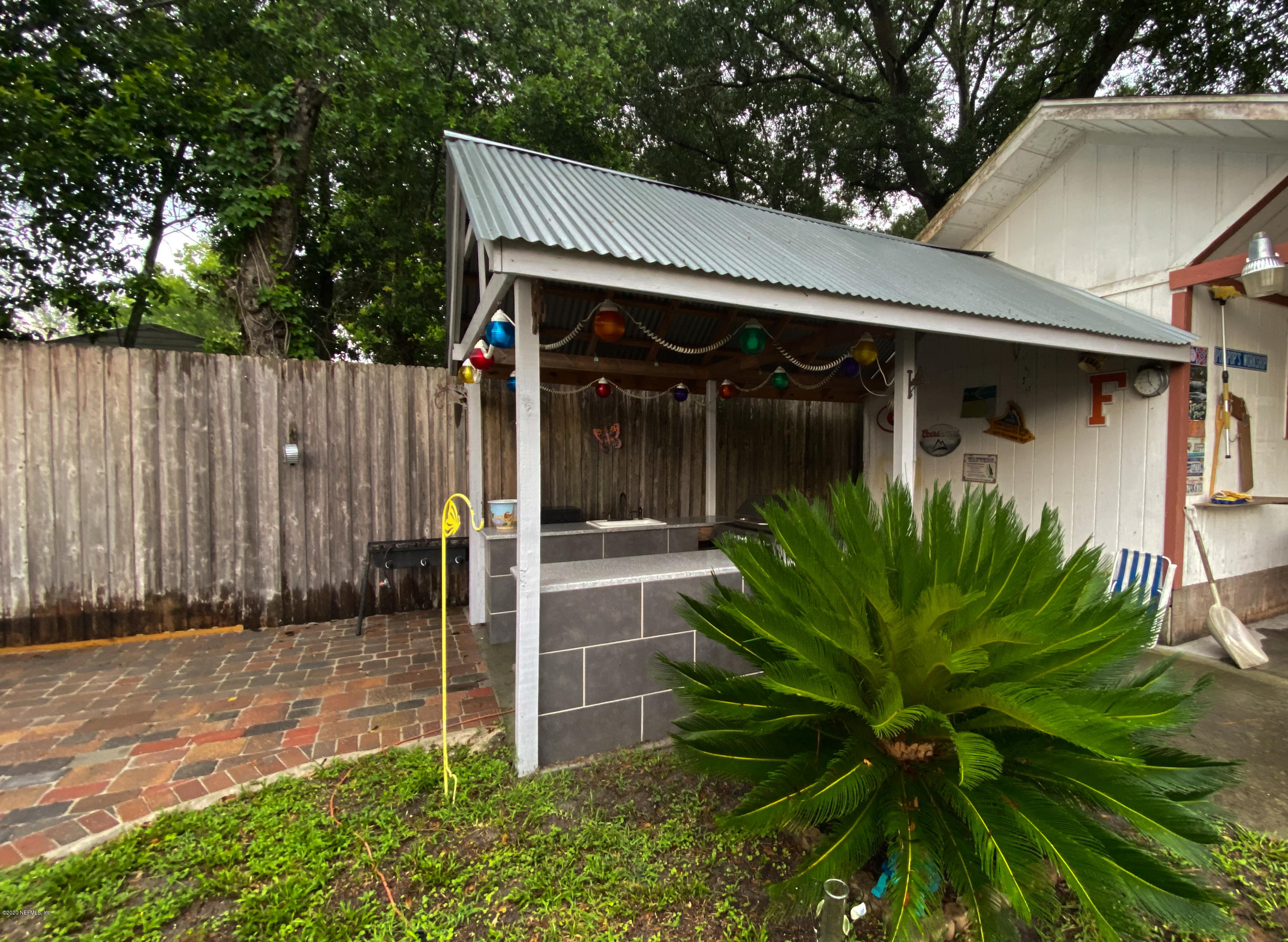 86116 Pages Dairy Road Yulee, FL 32097 - Photo 41 of 46 a view of a house with a small yard plants and a large tree