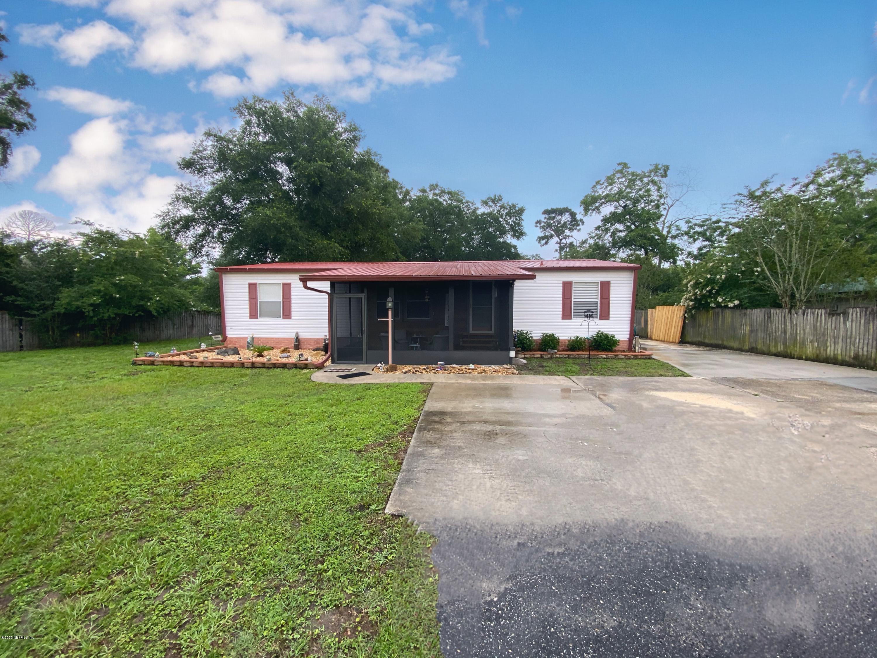 86116 Pages Dairy Road Yulee, FL 32097 - Photo 46 of 46 a front view of a house with a yard and porch