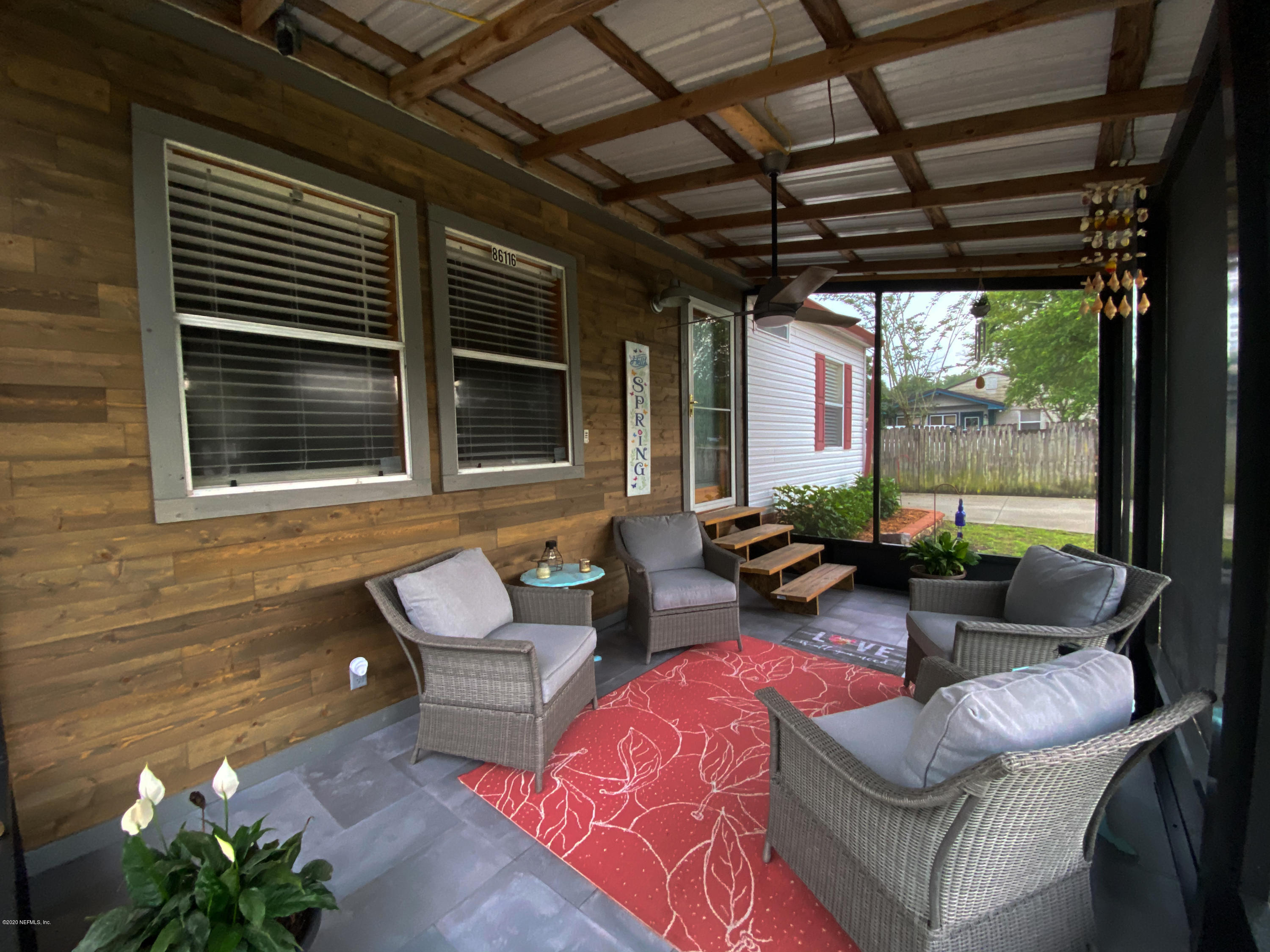 86116 Pages Dairy Road Yulee, FL 32097 - Photo 5 of 46 a outdoor living space with furniture and a potted plant