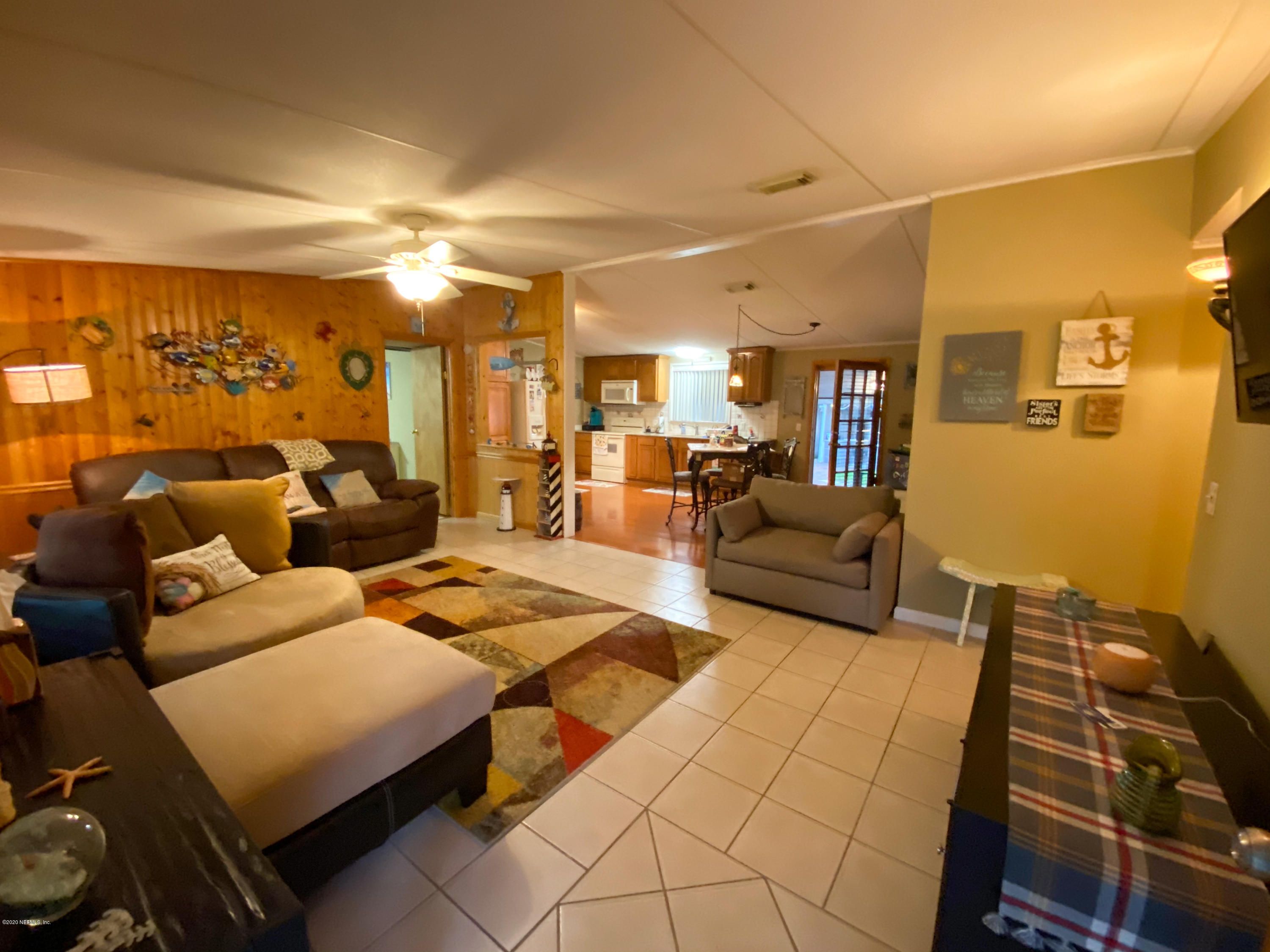 86116 Pages Dairy Road Yulee, FL 32097 - Photo 6 of 46 a living room with furniture and a flat screen tv