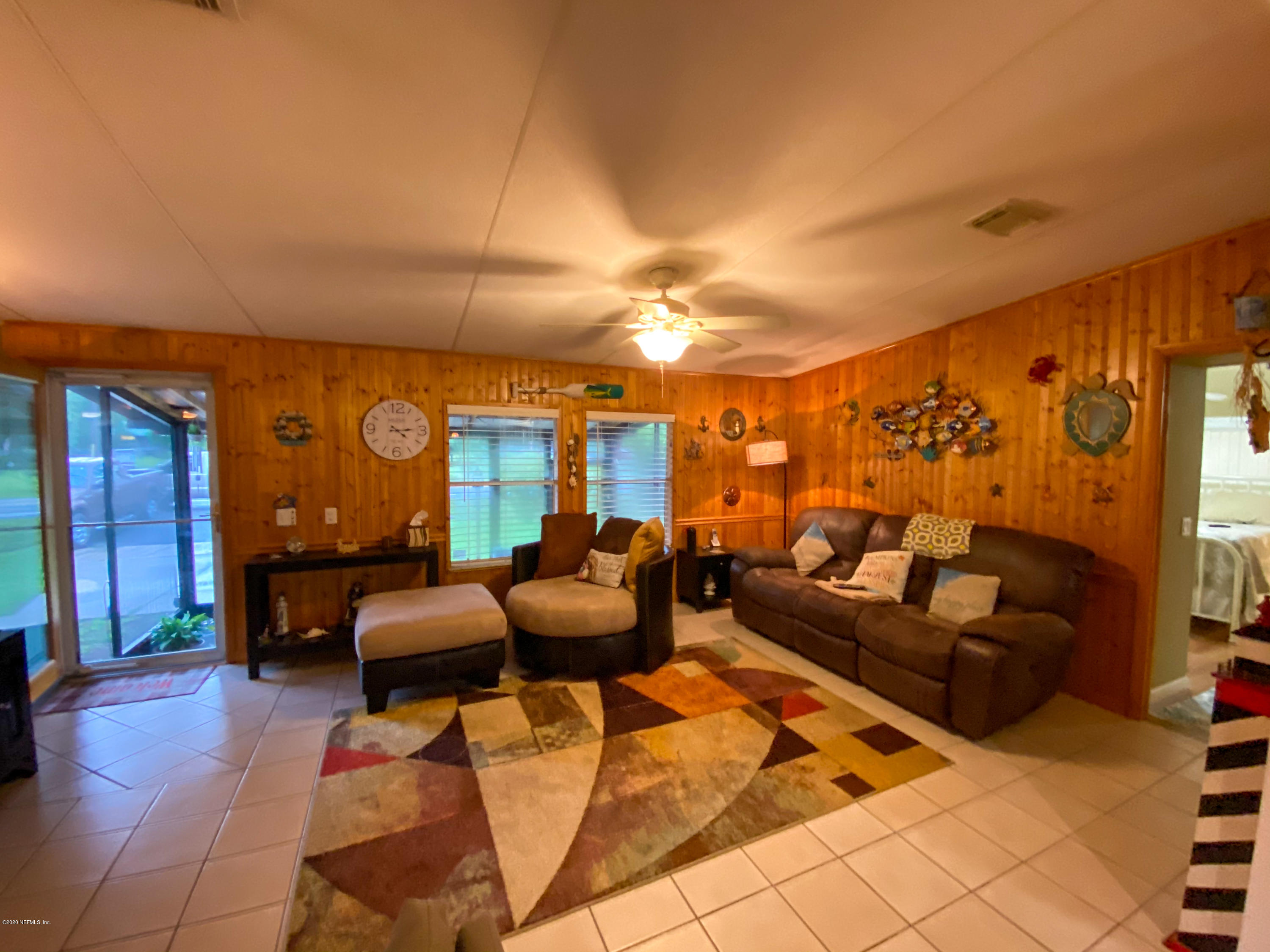 86116 Pages Dairy Road Yulee, FL 32097 - Photo 8 of 46 a living room with furniture a lamp and a potted plant