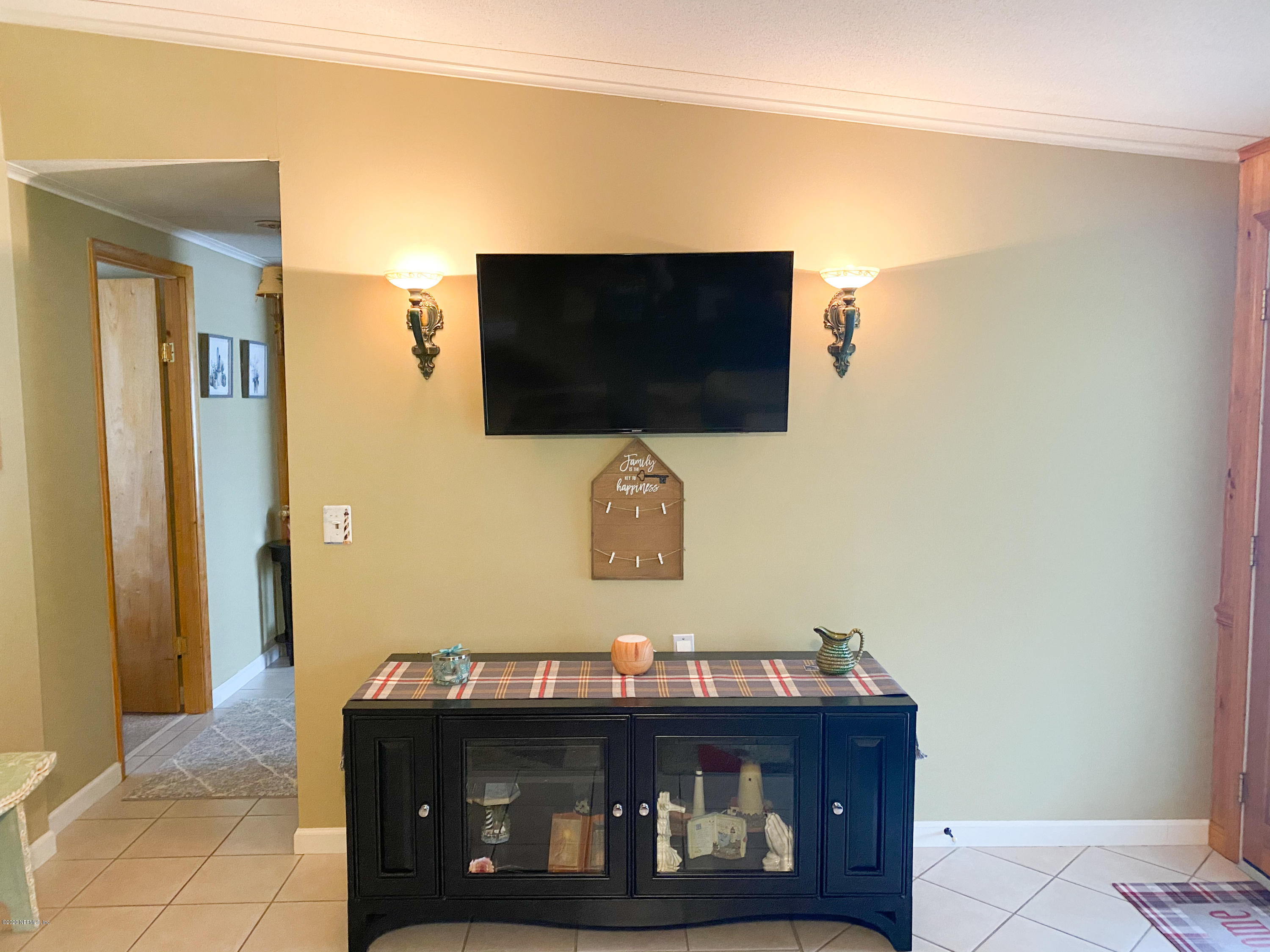 86116 Pages Dairy Road Yulee, FL 32097 - Photo 9 of 46 a living room with furniture and a flat screen tv