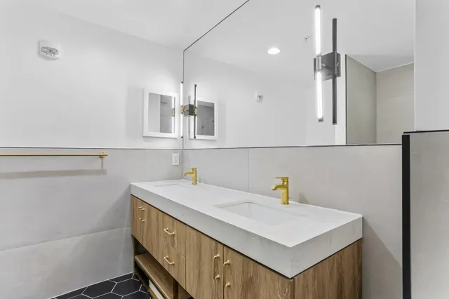 a kitchen that has a sink a stove and a refrigerator