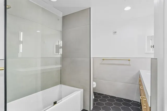 a bathroom with a bathtub and a shower