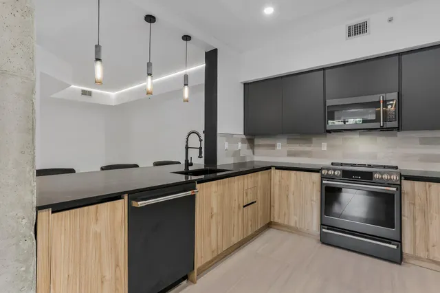 a kitchen with a sink and stainless steel appliances