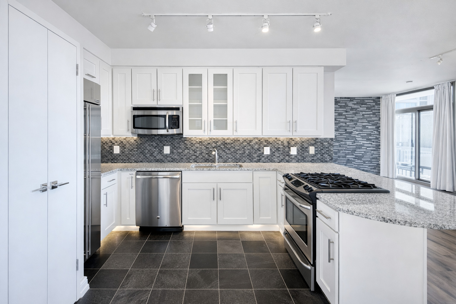 701 South Wells Street, Unit 1506 Chicago, IL 60607 - Photo 2 of 21 a kitchen with granite countertop a stove sink and cabinets