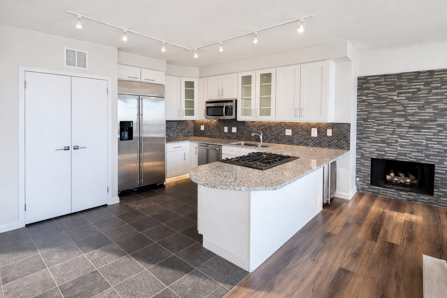 701 South Wells Street, Unit 1506 Chicago, IL 60607 - Photo 3 of 21 a kitchen with stainless steel appliances a refrigerator a stove top oven and kitchen island