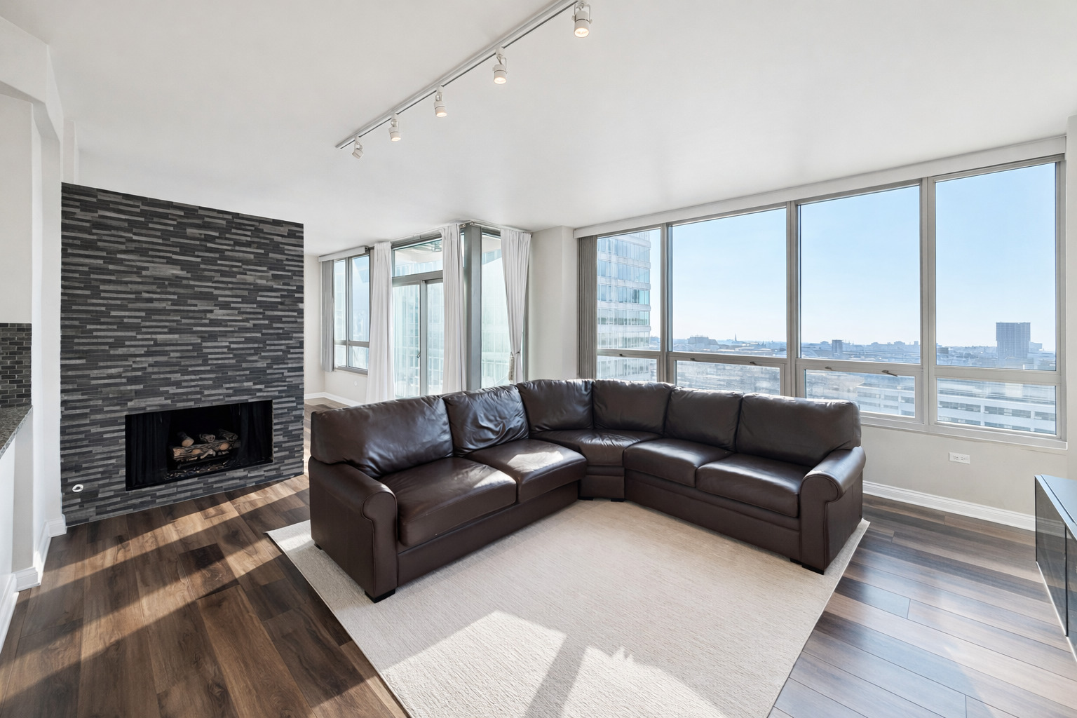 701 South Wells Street, Unit 1506 Chicago, IL 60607 - Photo 4 of 21 a living room with furniture and a fireplace