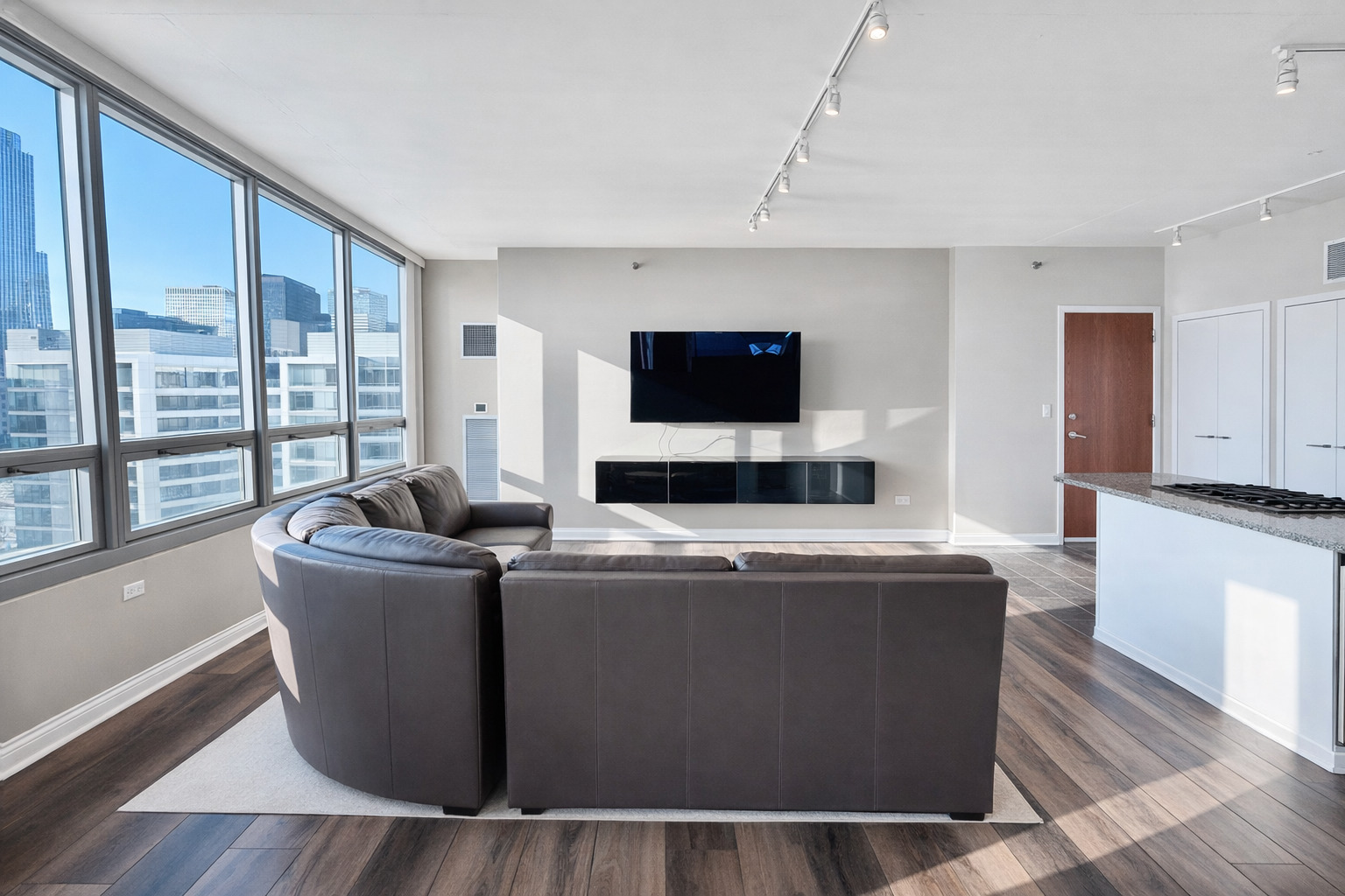 701 South Wells Street, Unit 1506 Chicago, IL 60607 - Photo 6 of 21 a living room with a couch and a flat screen tv