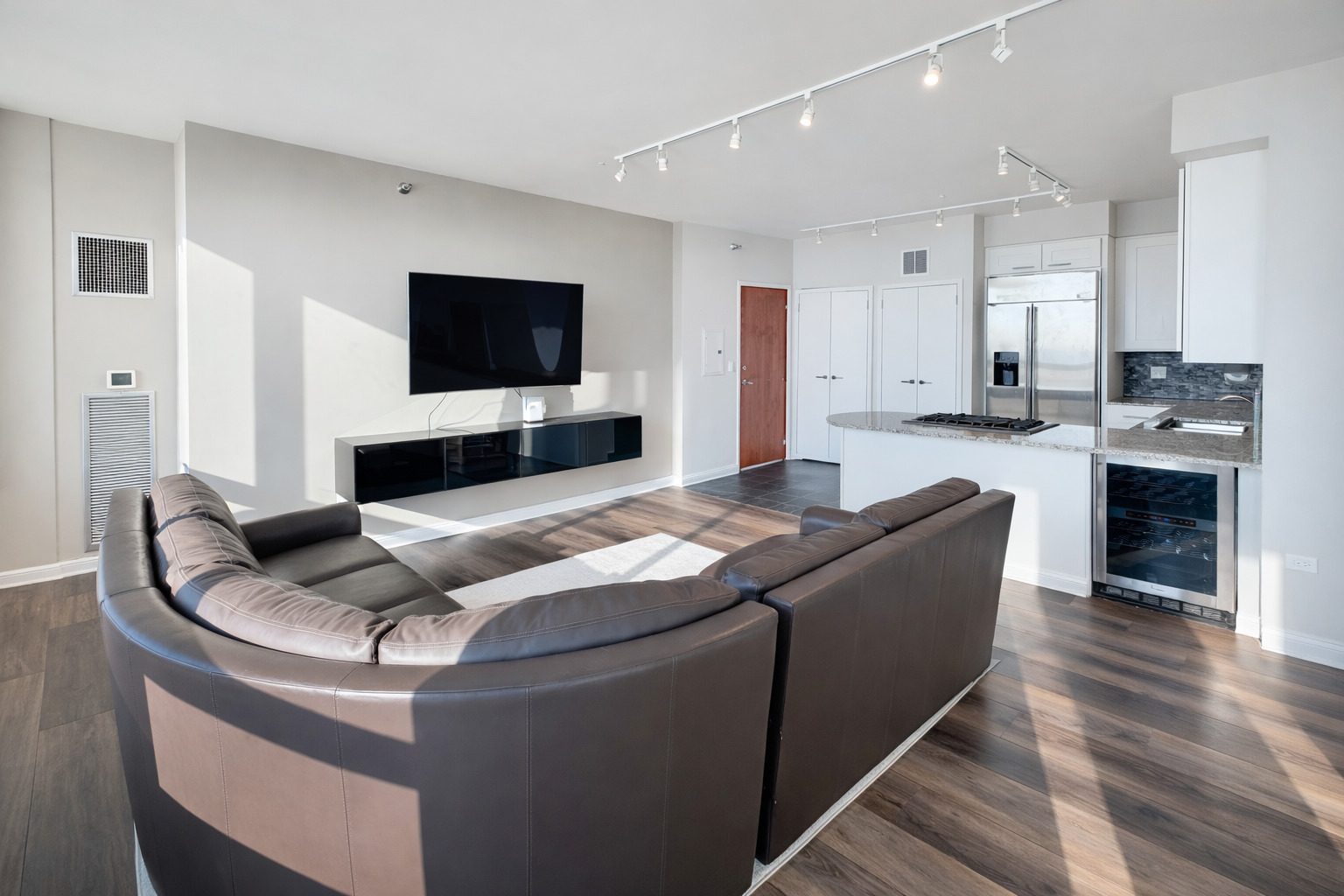 701 South Wells Street, Unit 1506 Chicago, IL 60607 - Photo 7 of 21 a living room with furniture and a flat screen tv