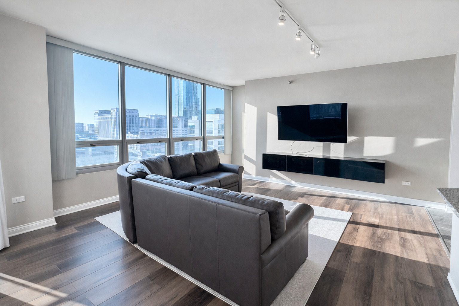 701 South Wells Street, Unit 1506 Chicago, IL 60607 - Photo 8 of 21 a living room with furniture and a flat screen tv