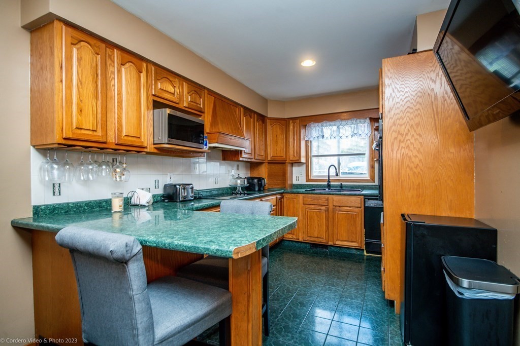478 Third Street Fall River, MA 02721 - Photo 13 of 35 a kitchen with stainless steel appliances granite countertop a sink a stove counter space and cabinets