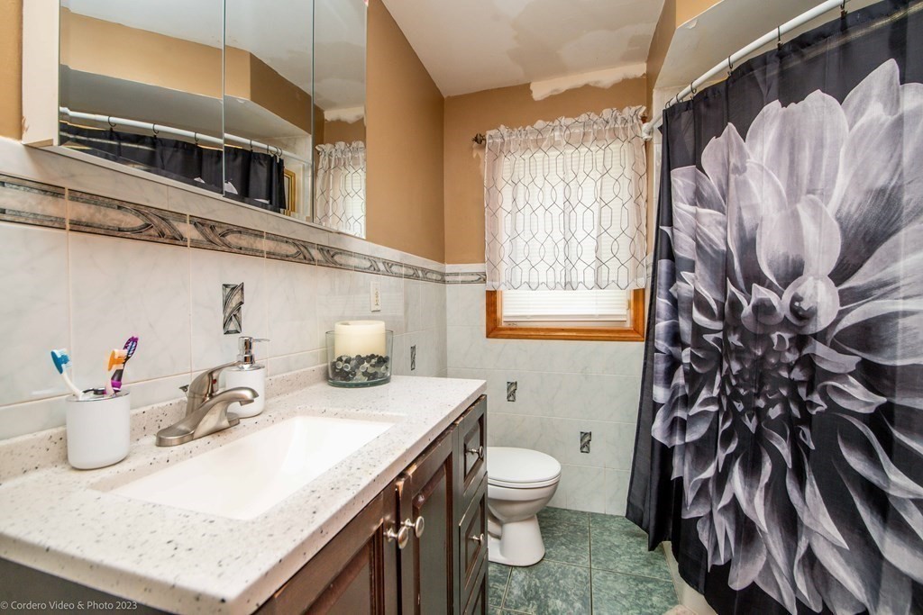 478 Third Street Fall River, MA 02721 - Photo 24 of 35 a bathroom with a sink a toilet and shower curtain