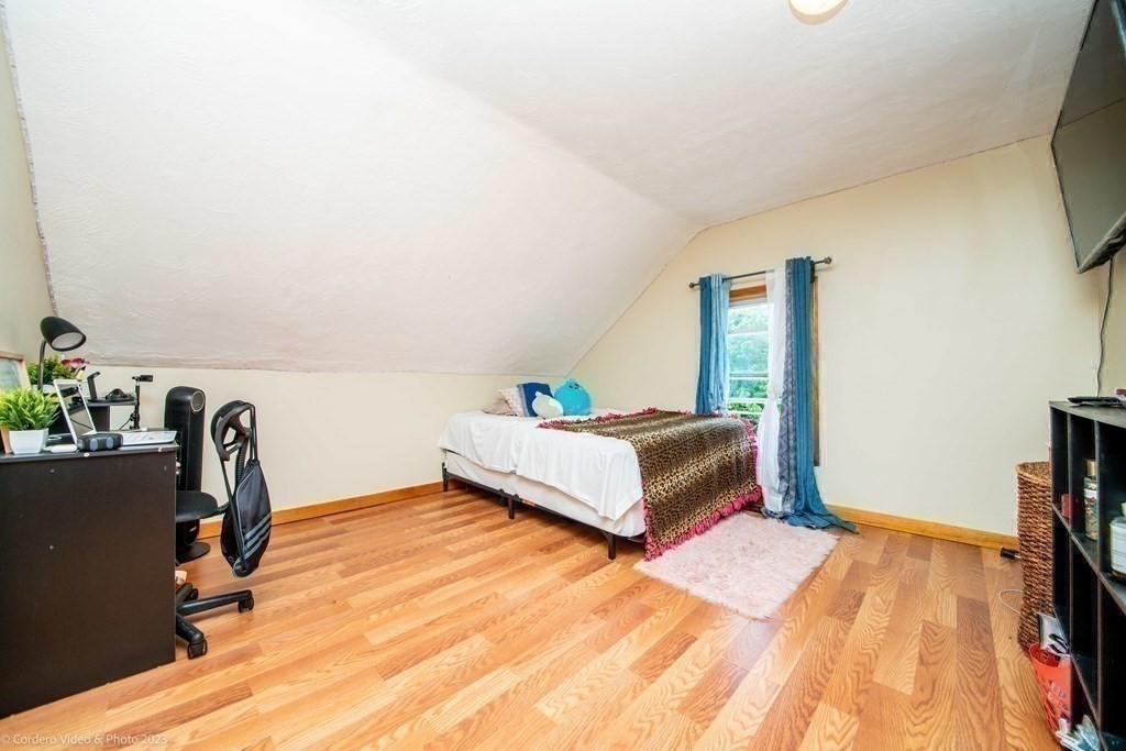 478 Third Street Fall River, MA 02721 - Photo 29 of 35 a bedroom with a bed and a flat screen tv