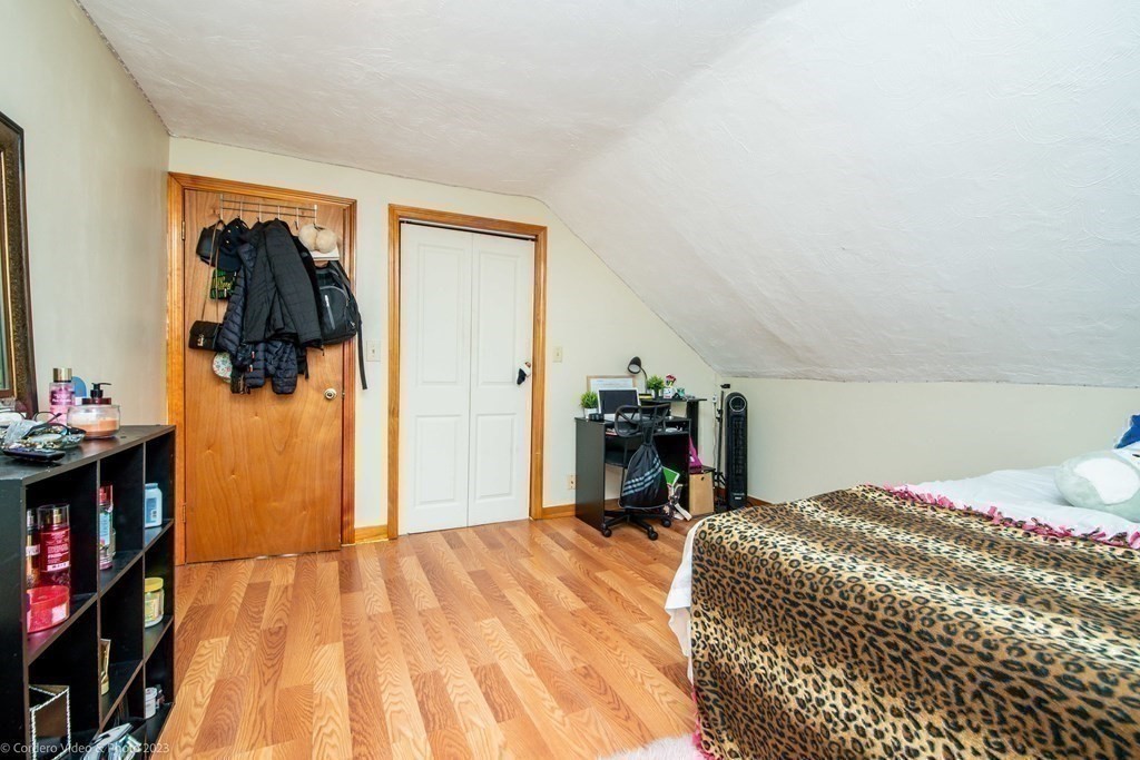 478 Third Street Fall River, MA 02721 - Photo 31 of 35 a bedroom with a bed and a book shelf