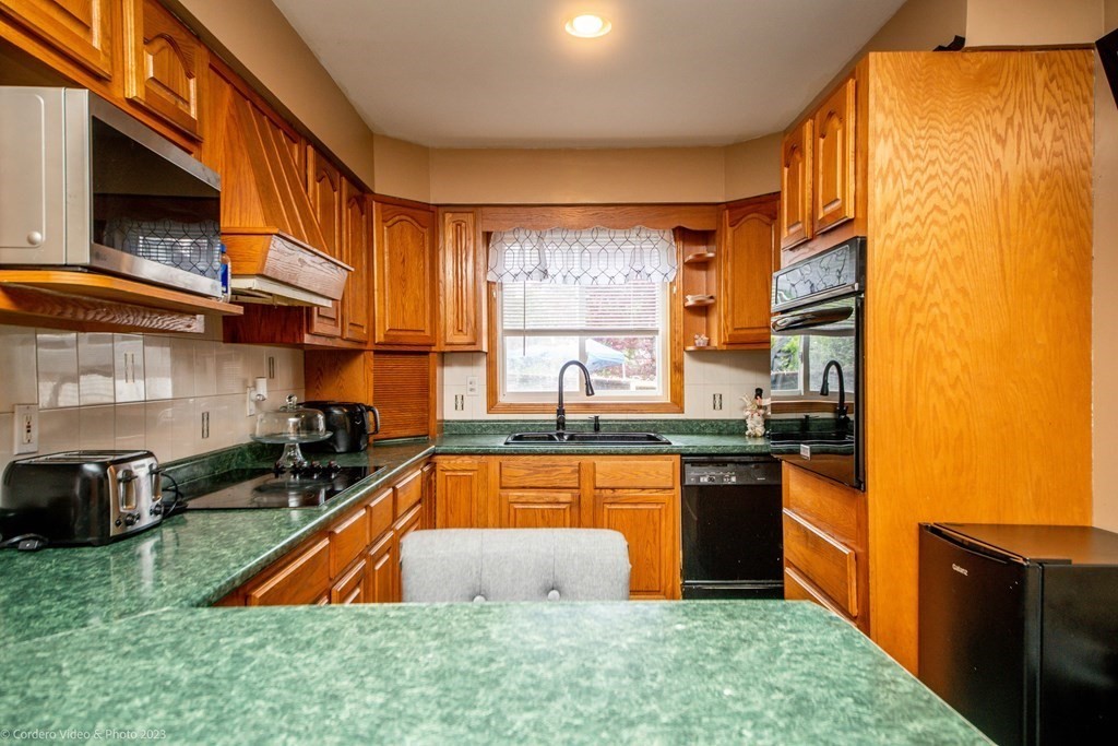 478 Third Street Fall River, MA 02721 - Photo 6 of 35 a kitchen with stainless steel appliances granite countertop a sink a stove and a refrigerator