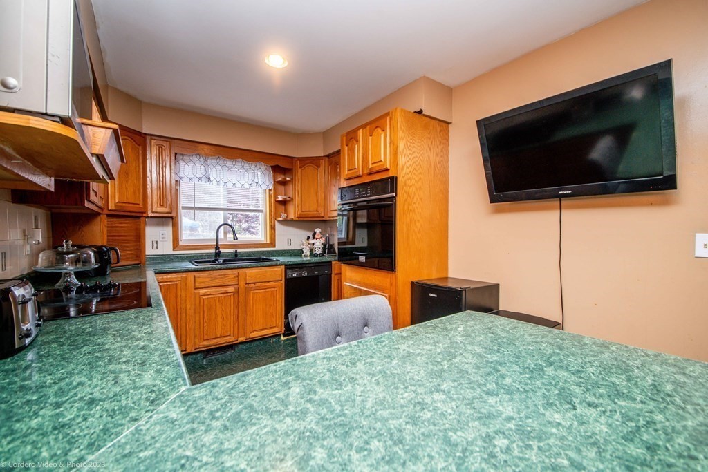 478 Third Street Fall River, MA 02721 - Photo 10 of 35 a living room with furniture and a flat screen tv