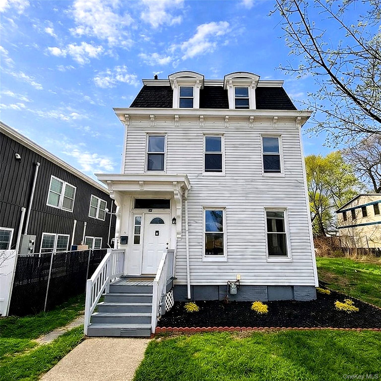 a front view of a house with a yard