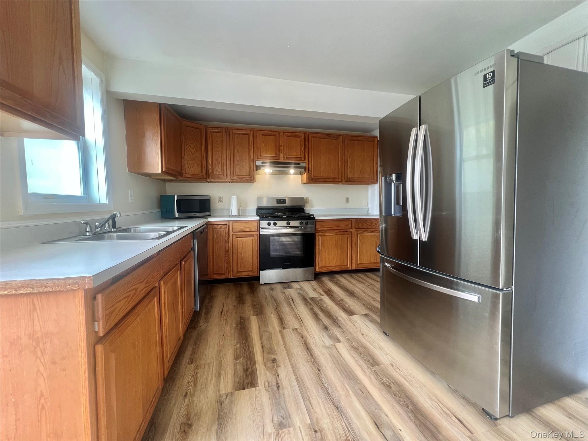 34 Smith Street Poughkeepsie, NY 12601 - Photo 15 of 46 a kitchen with stainless steel appliances granite countertop a refrigerator a sink dishwasher a stove top oven a refrigerator and dishwasher