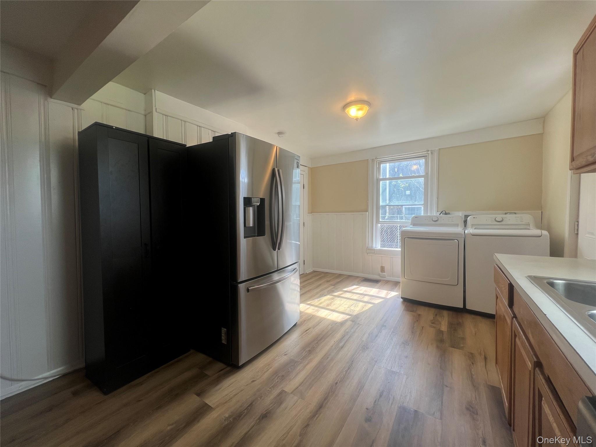 34 Smith Street Poughkeepsie, NY 12601 - Photo 17 of 46 a kitchen with stainless steel appliances a refrigerator and a stove top oven