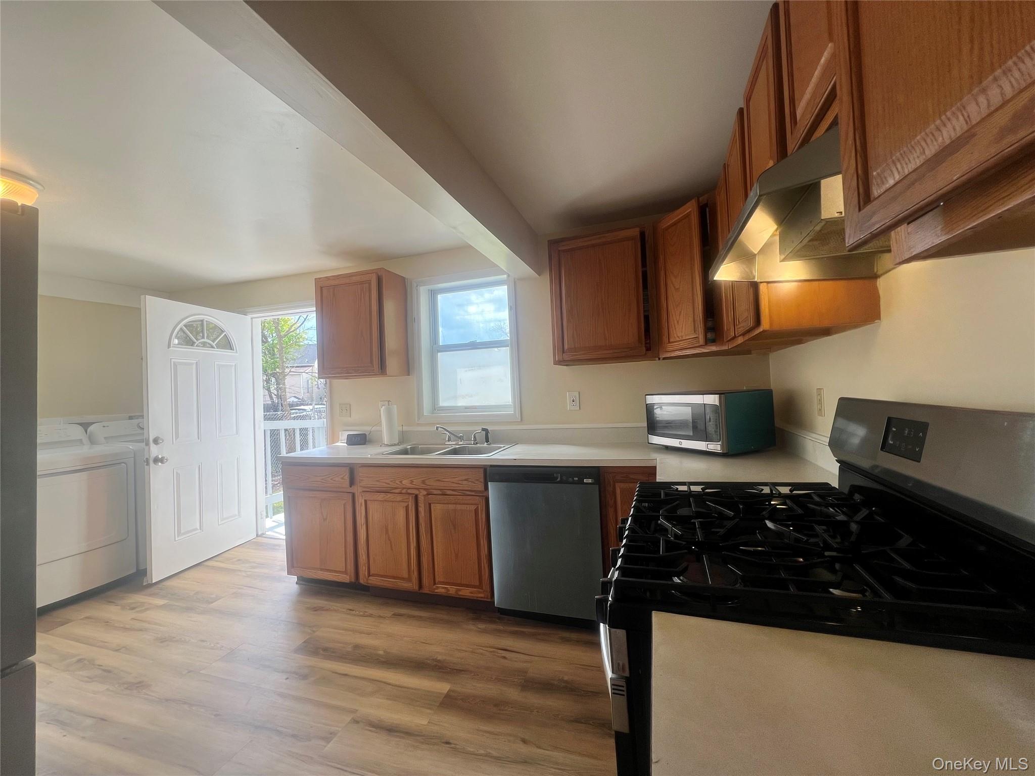 34 Smith Street Poughkeepsie, NY 12601 - Photo 18 of 46 a kitchen with stainless steel appliances granite countertop a sink stove and cabinets
