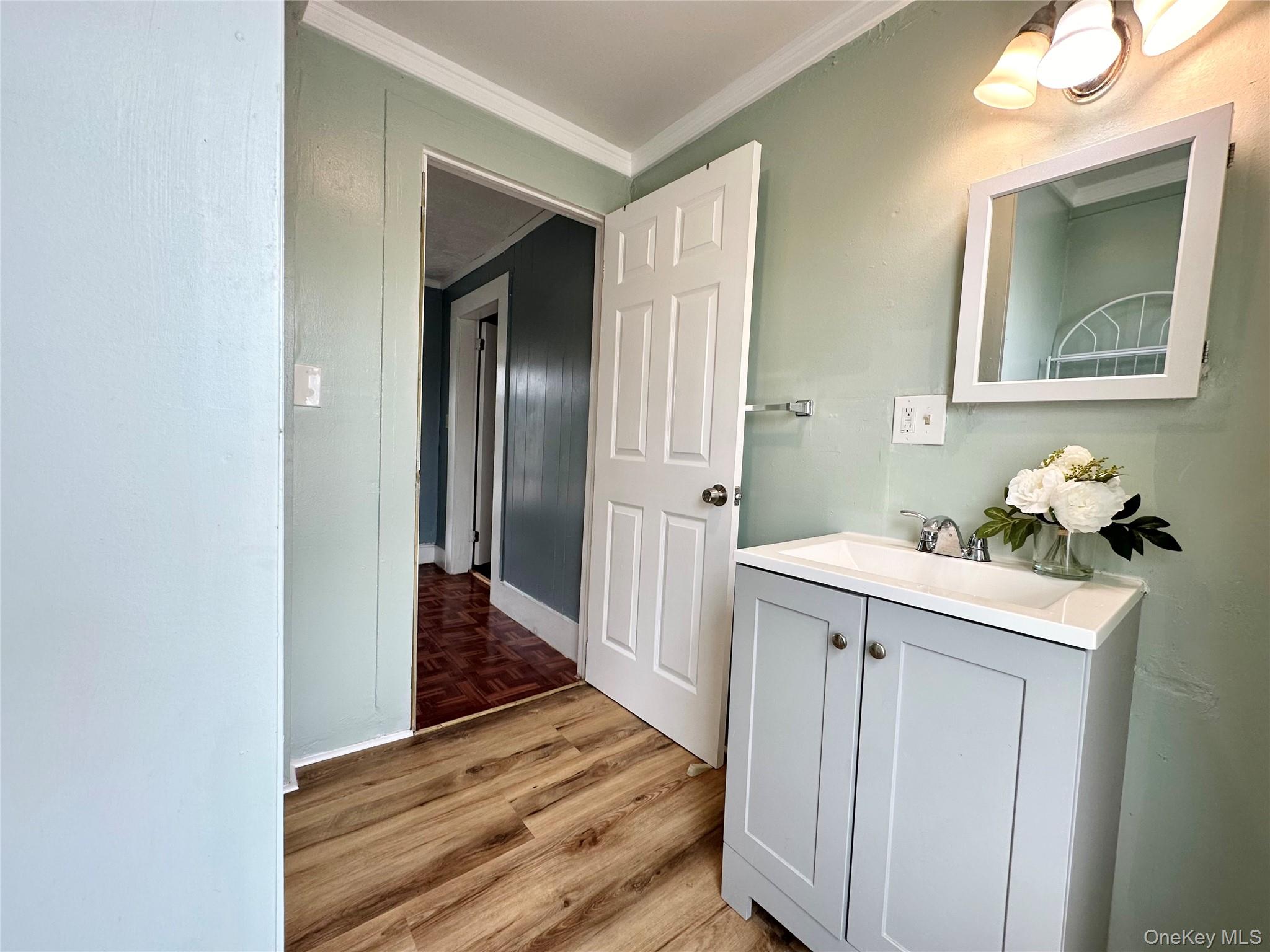 34 Smith Street Poughkeepsie, NY 12601 - Photo 35 of 46 a view of a hallway to a room with wooden floor and cabinet