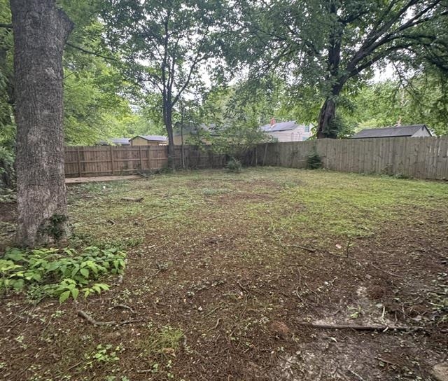 1370 East Alcy Road Memphis, TN 38106 - Photo 8 of 8 Expansive rear yard featuring mature trees and wood privacy fencing