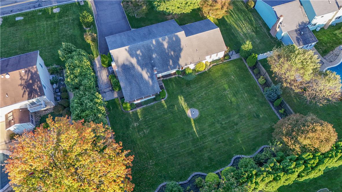 3915 Hecktown Road Bethlehem, PA 18020 - Photo 41 of 42 An aerial perspective reveals a generous green lawn bordered by mature trees and paved driveway.