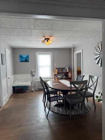 a view of a dining room with furniture and window