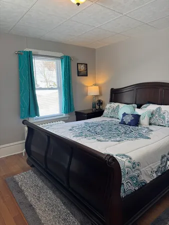 a bedroom with a bed and window