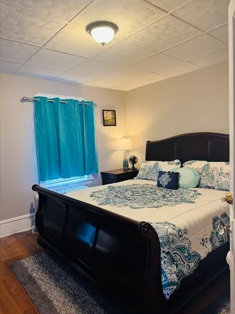 a bedroom with a bed and a mirror