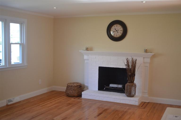 147 Straightway Hyannis, MA 02601 - Photo 3 of 31 a view of a livingroom with wooden floor and a fireplace