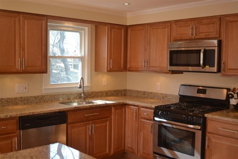 147 Straightway Hyannis, MA 02601 - Photo 6 of 31 a kitchen with granite countertop cabinets stainless steel appliances and a sink