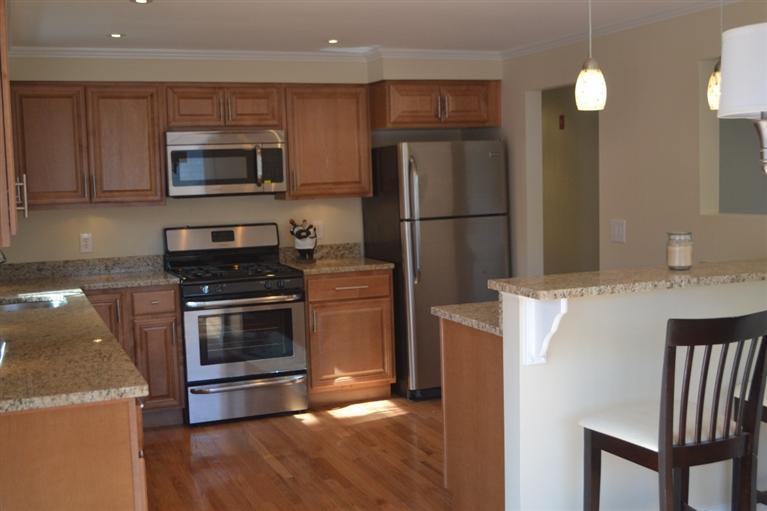 147 Straightway Hyannis, MA 02601 - Photo 7 of 31 a kitchen with stainless steel appliances and wooden cabinets